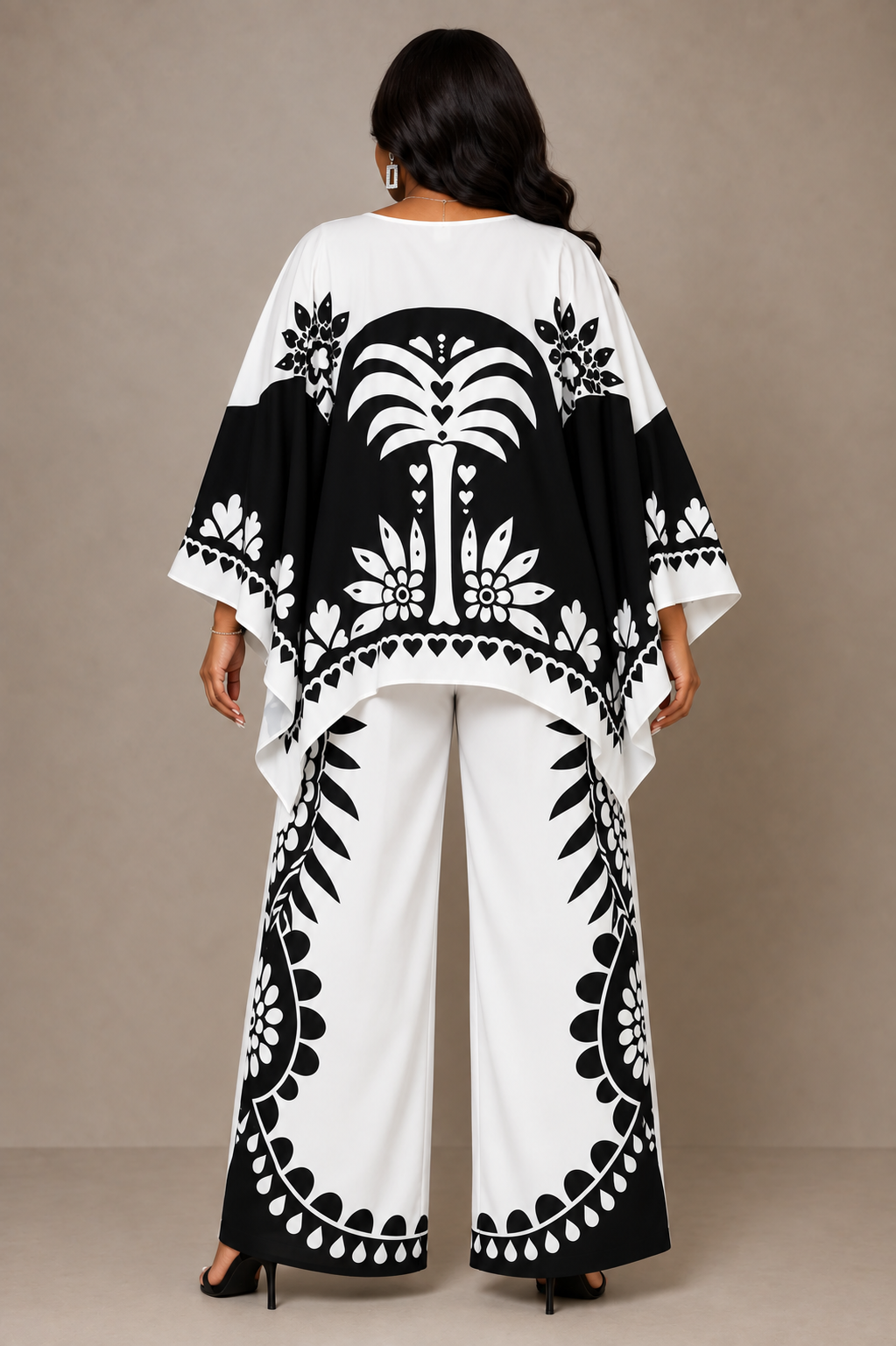 Back view of a plus size model wearing the For Her NYC Black & White Maxi Tunic Pant Set - U0707 with a flowing printed tunic and coordinating wide-leg graphic-print pants
