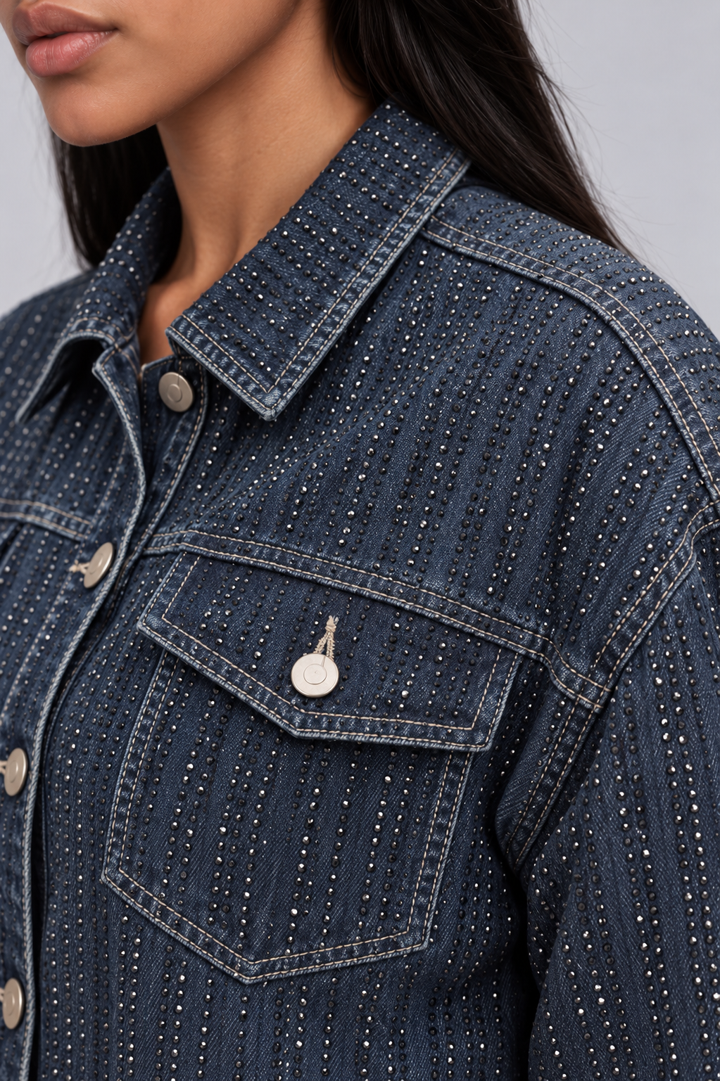 Close-up of a model wearing the For Her NYC Rhinestone Embellished Denim Jacket - 82978, highlighting the rhinestone pattern, collar, and chest pocket