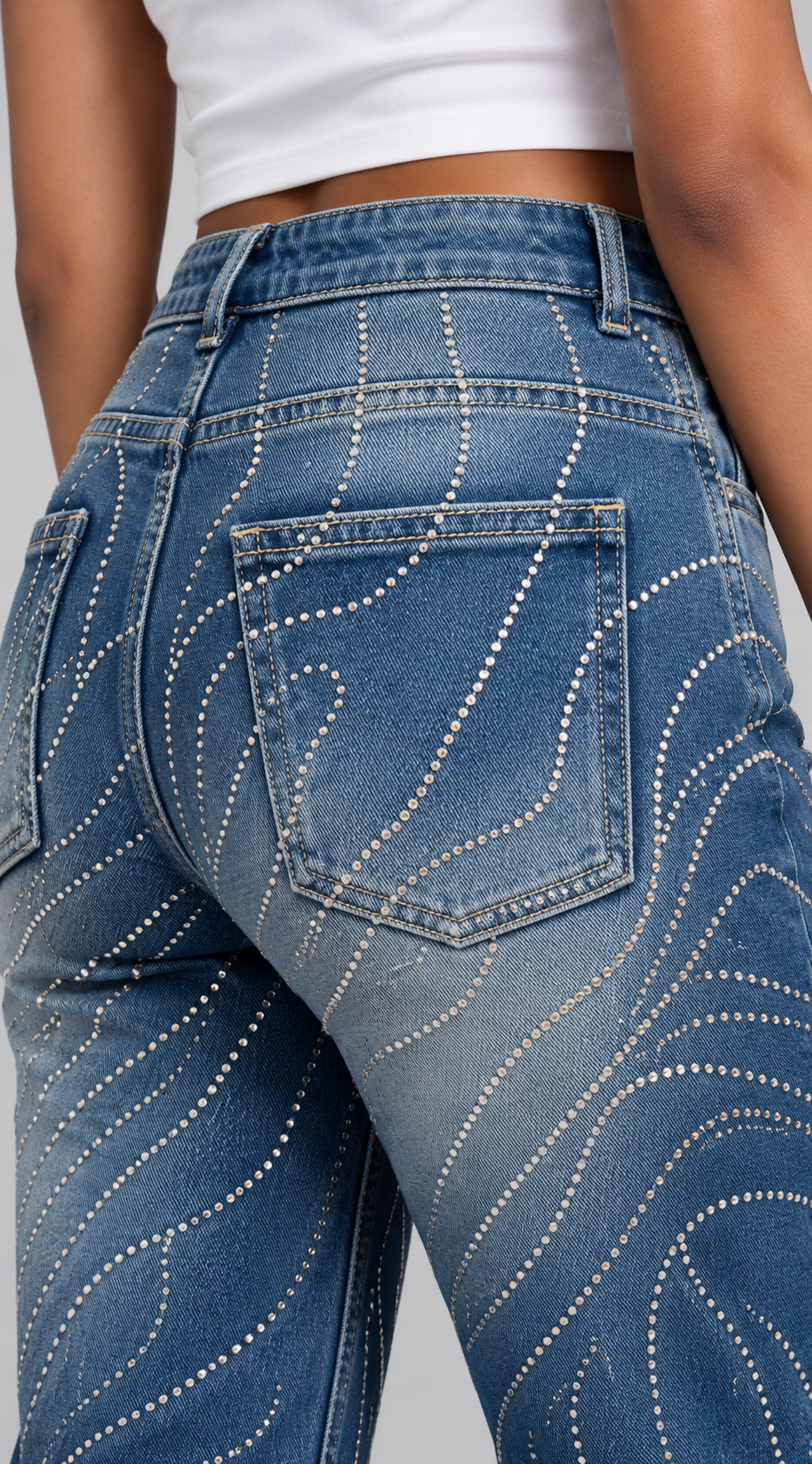 Back-pocket close-up of a model wearing the For Her NYC Rhinestone Swirl Wide-Leg Denim Jeans - 83071 with allover rhinestone detailing