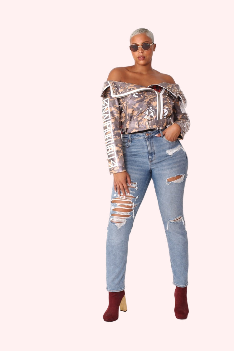 Model wearing off-shoulder camo print leather jacket in a full front pose