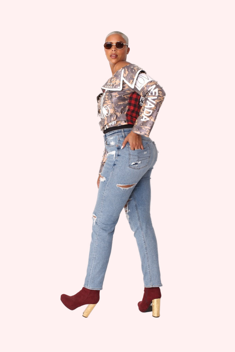 Model wearing camo print leather jacket from the side angle