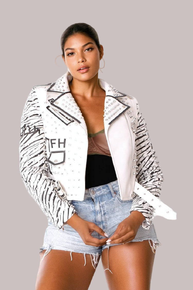 Faux leather jacket with detachable sleeves styled with denim shorts, front pose.