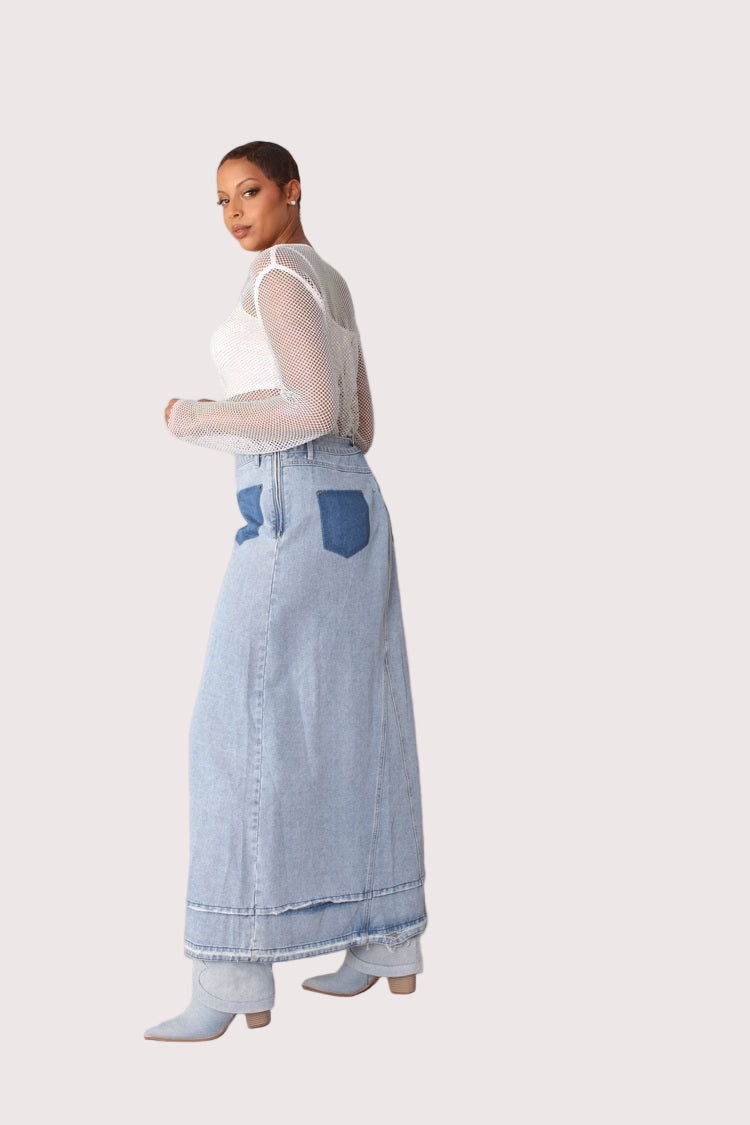 Side view of light wash long denim skirt featuring released hem and crystal embellishments, highlighting length and side slit, For Her NYC