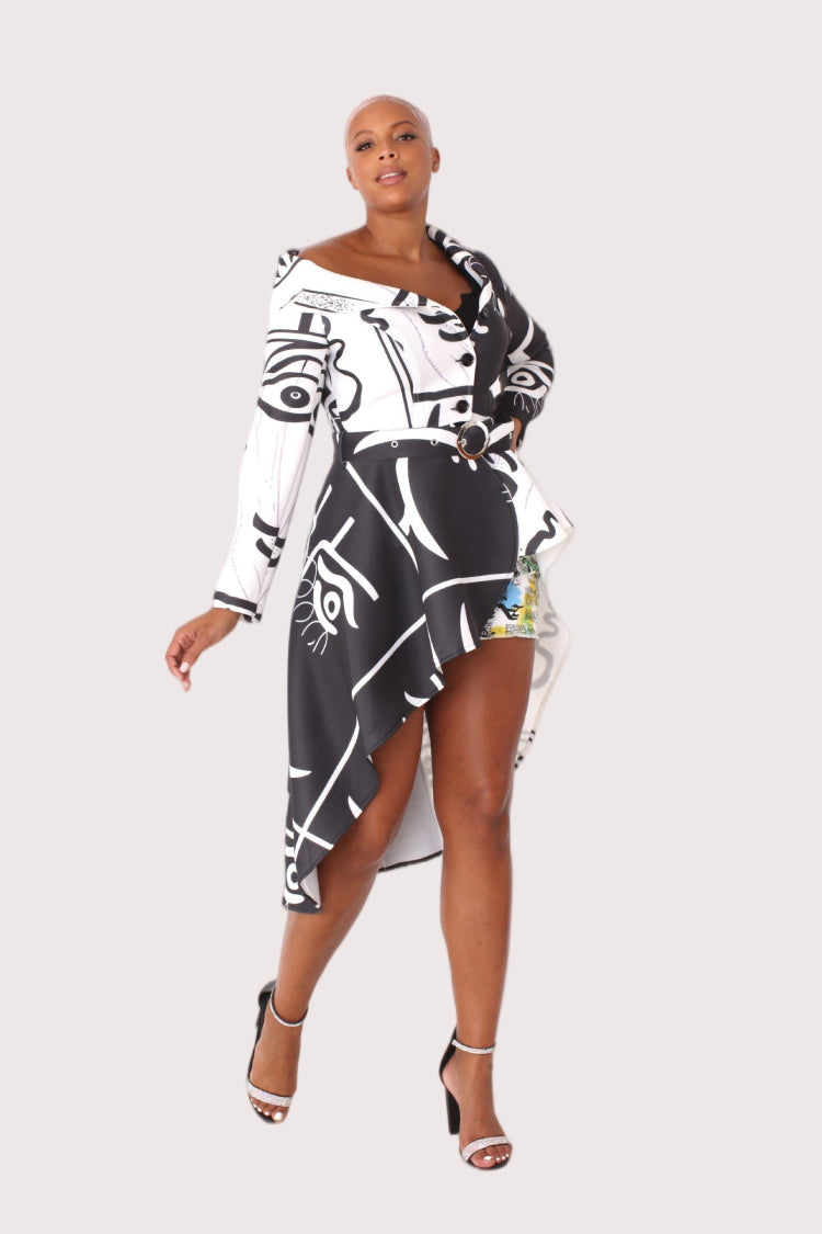 Model wearing long scuba abstraction print belted jacket in black and white, front-facing hero pose highlighting bold abstract pattern, cinched waist belt, and statement silhouette by For Her NYC