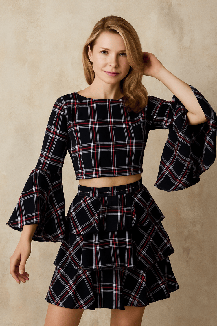 Navy multi plaid bell sleeve top with flared sleeves, front studio pose.