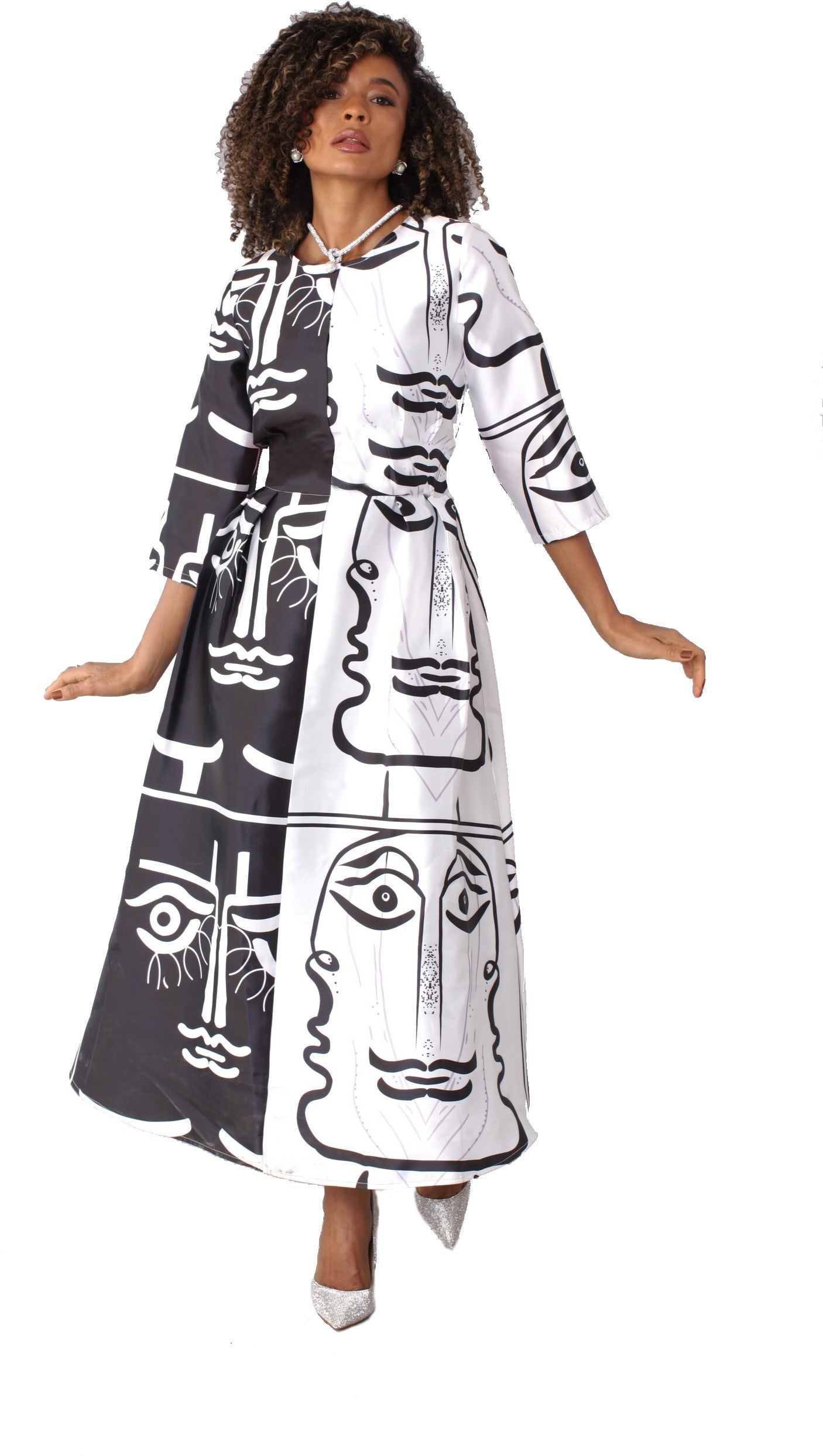 Model wearing black swirl print plus size satin dress with rhinestone brooch, front standing pose by Tally Taylor
