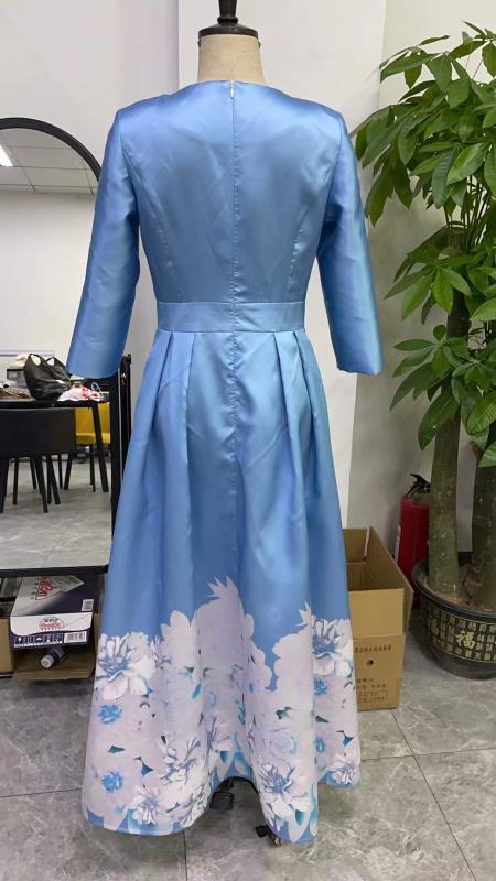 Back view of slate blue plus size satin dress with rhinestone brooch shown on mannequin by Tally Taylor