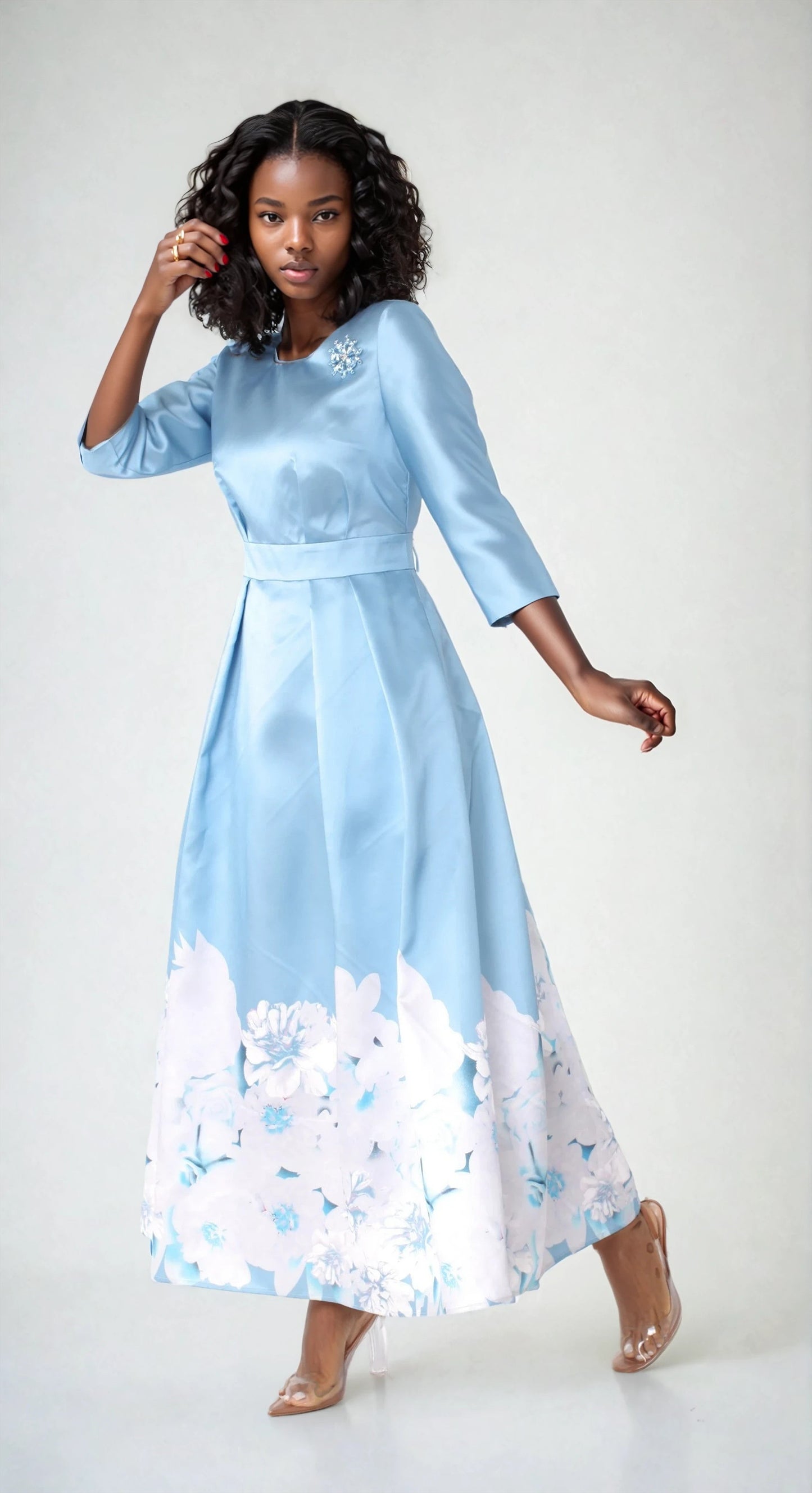 Model wearing slate blue plus size satin dress with rhinestone brooch, front standing pose by Tally Taylor