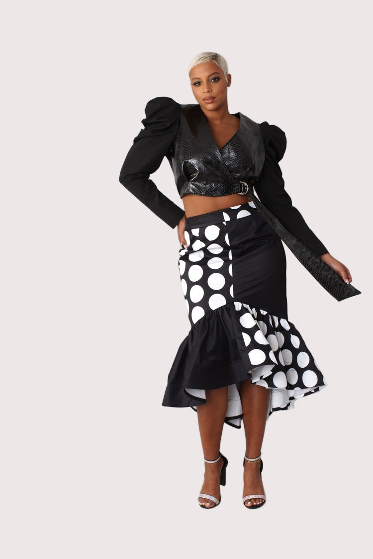 Black and white dotted high low skirt front view with dramatic hem detail.