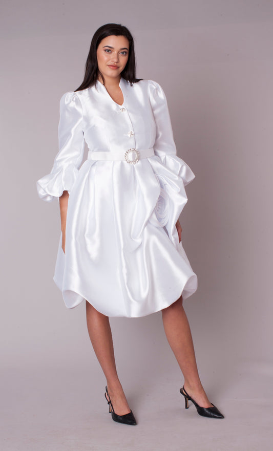 White puff sleeve fit and flare occasion dress with statement belt and rosette detail, model standing front pose wearing black heels – Tally Taylor