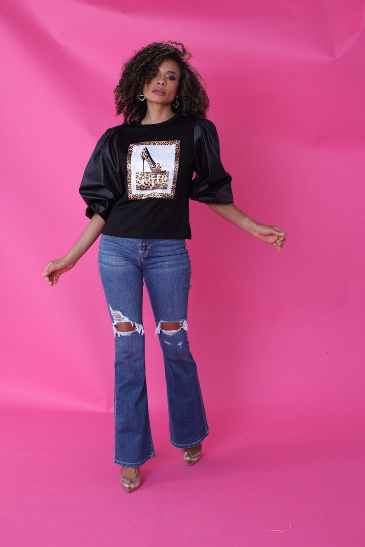 Close front pose showing leopard graphic detail and puff faux leather sleeves – For Her NYC