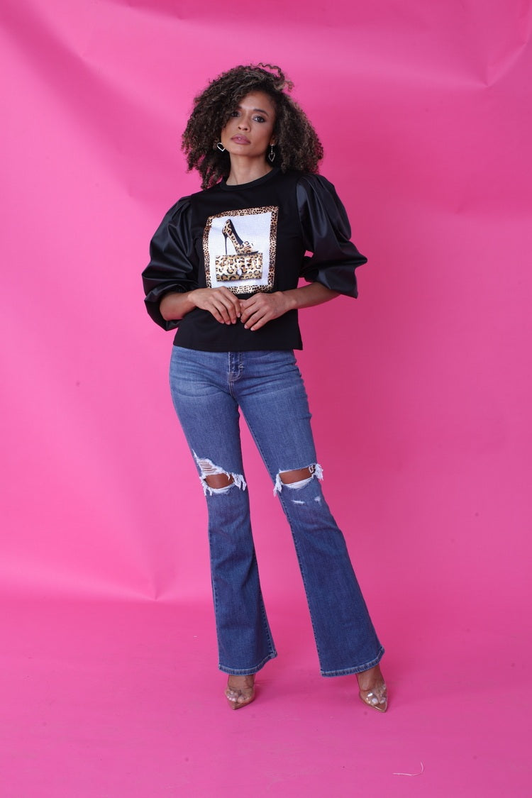 Close front pose showing leopard graphic detail and puff faux leather sleeves – For Her NYC