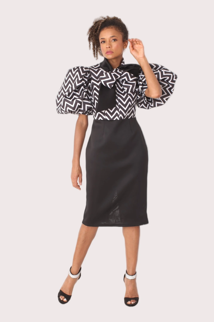 Black and white puff sleeve zigzag print dress with bow detail, full front standing pose.