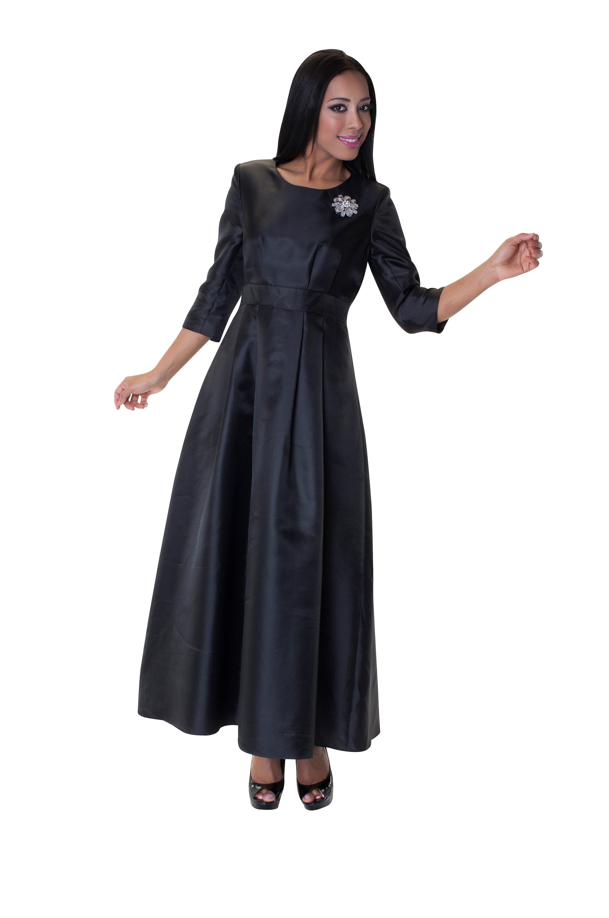Black satin dress with rhinestone brooch and 3/4 sleeves, model standing front pose – Tally Taylor