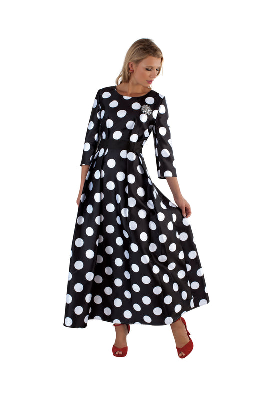 Black and white polka dot satin dress with rhinestone brooch and 3/4 sleeves, model standing front pose holding skirt – Tally Taylor