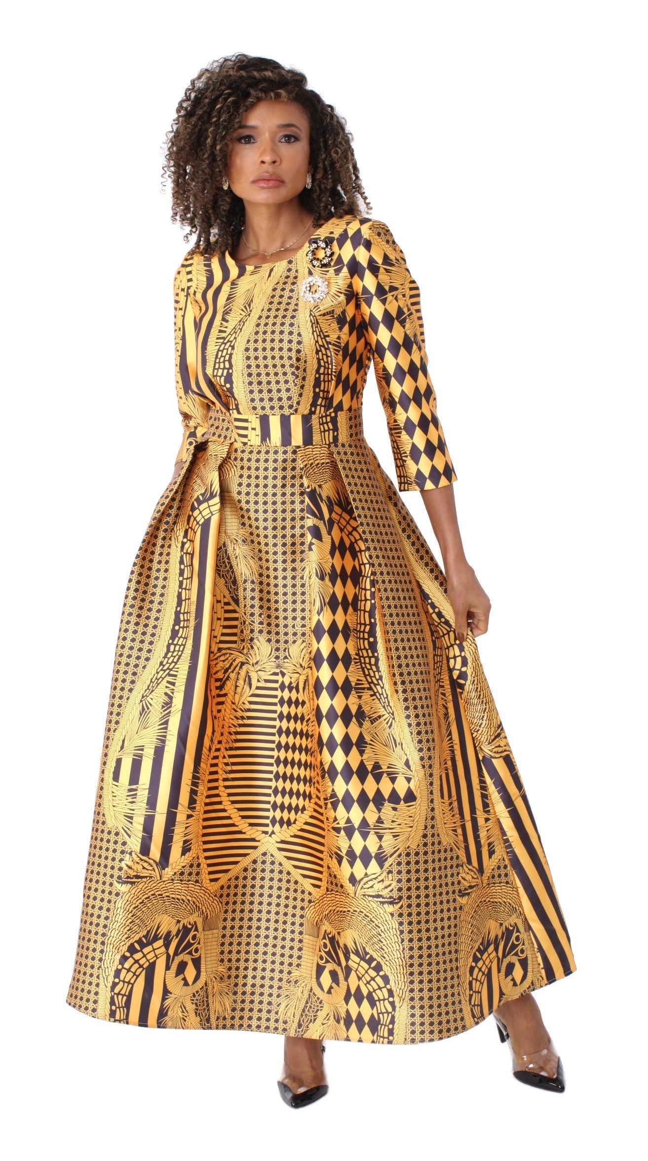 Gold and black printed satin dress with rhinestone brooch, model standing front pose – Tally Taylor