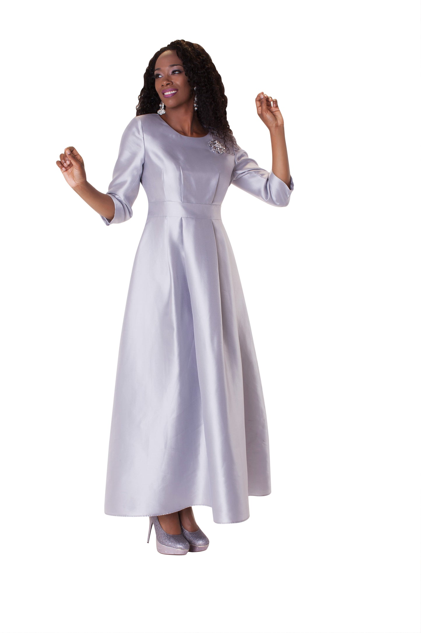 Silver satin dress with rhinestone brooch and 3/4 sleeves, model standing front pose – Tally Taylor