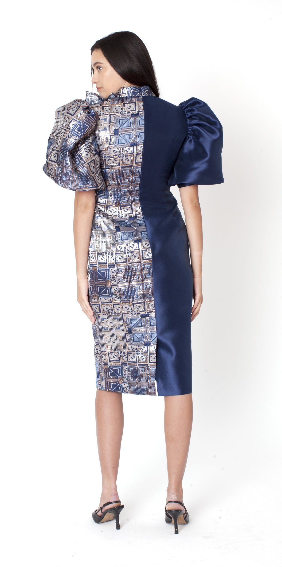 Angled view of sculpted mosaic sheath dress highlighting jacquard panel and shoulder detail in blue multi Tally Taylor