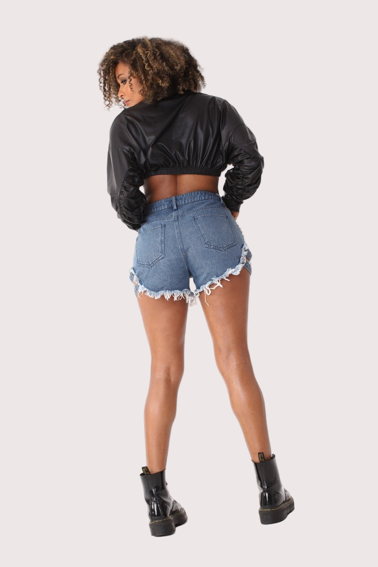Back view of studded denim shorts with pearl embellishments showing fitted waist and distressed detailing, modern streetwear style, For Her NYC