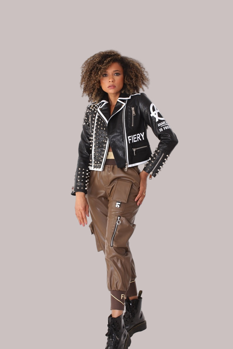 Model posing confidently in black studded leather jacket with metal studs and fitted silhouette, edgy fashion outerwear, For Her NYC