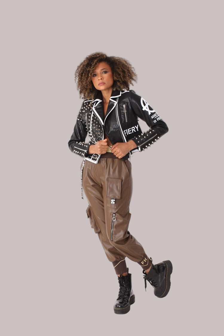 Full body walking pose wearing black studded leather jacket styled with cargo pants and combat boots, rebellious street style look, For Her NYC