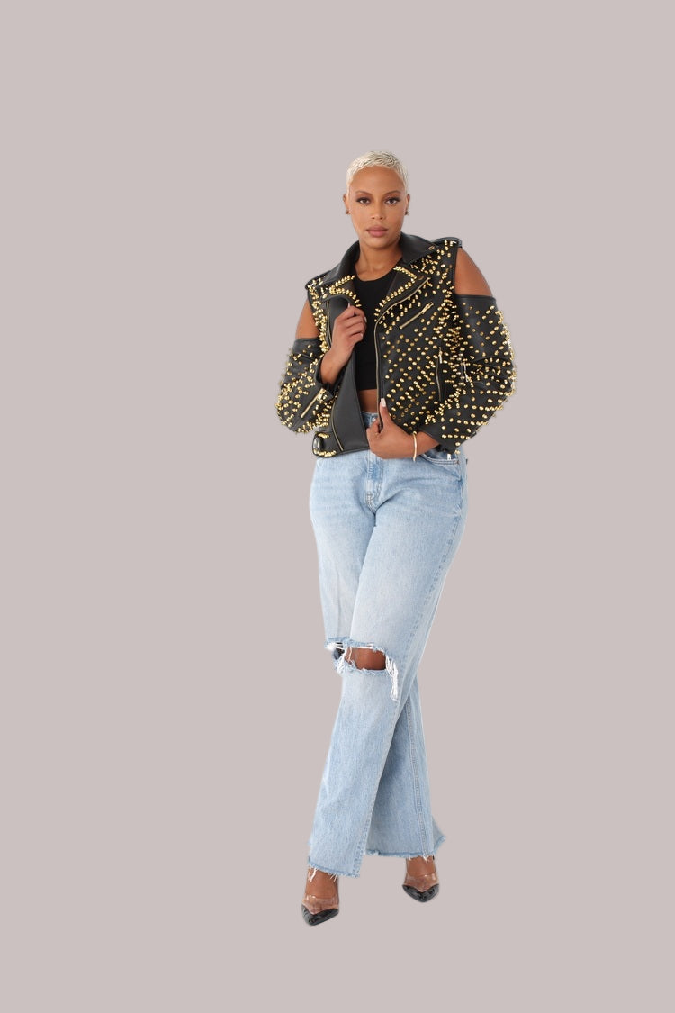 Black/Gold studded pleather moto jacket with open shoulder cutouts, front walking pose highlighting statement studs by For Her NYC