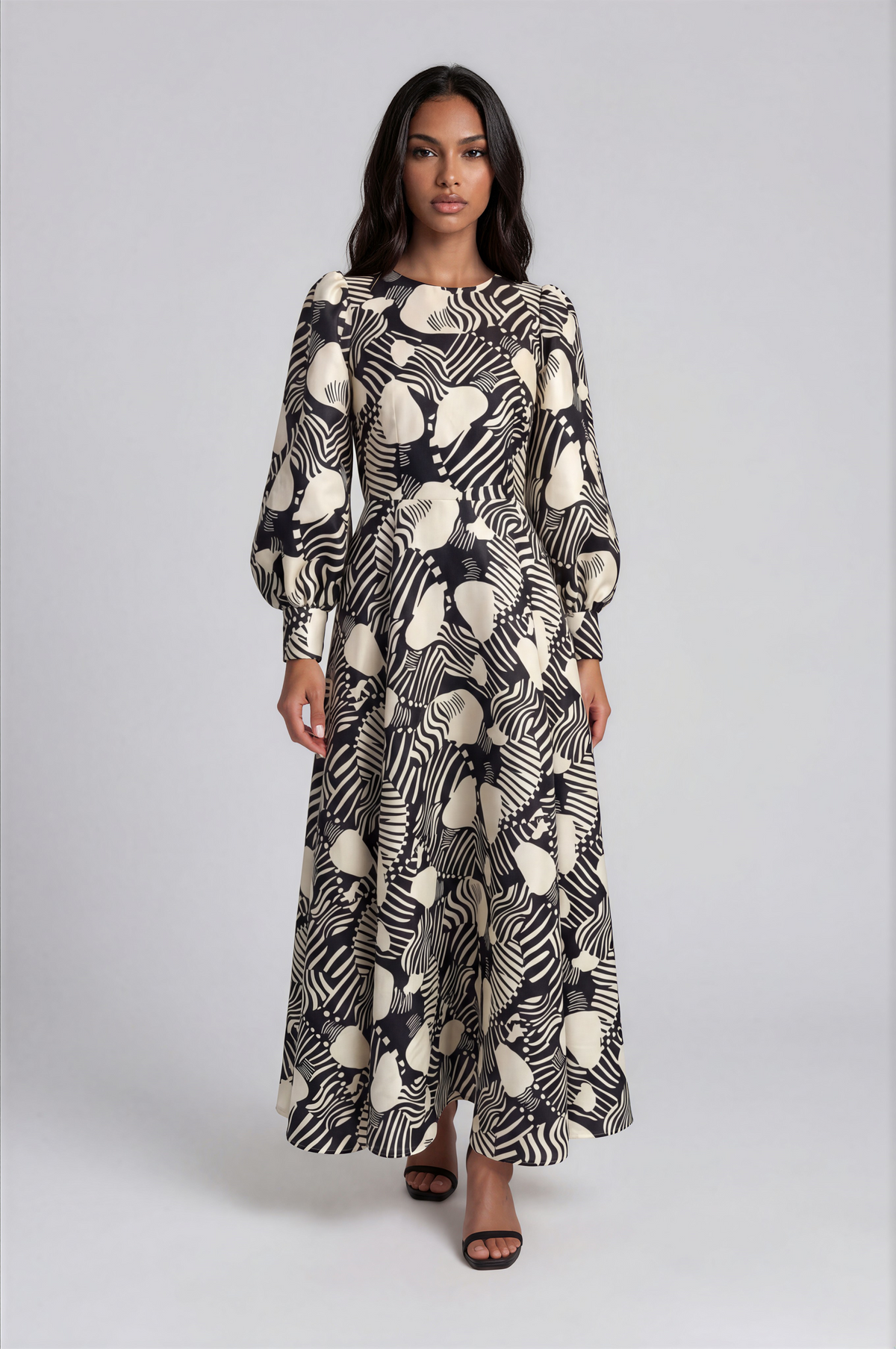 Tally Taylor black and white floral brocade maxi dress featuring bishop sleeves, a round neckline, and a decorative brooch.