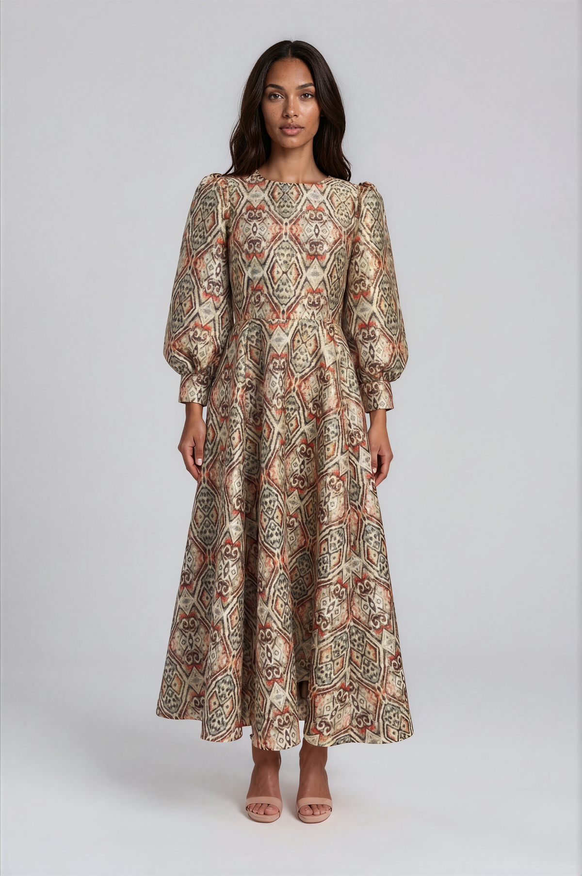 Tally Taylor burnt orange multi floral brocade maxi dress featuring bishop sleeves, a round neckline, and a decorative brooch.