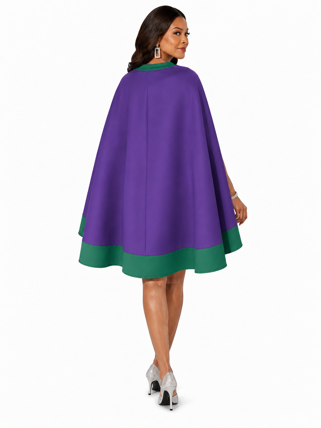 Back view of a model wearing the Tally Taylor Plus Size Cape Sheath Dress - U0617W in purple with green trim and a flowing cape