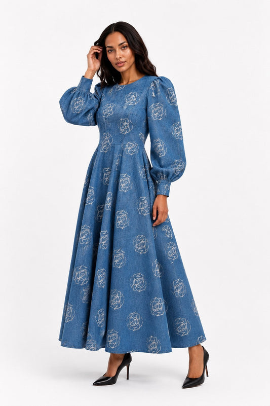 Front view of a model wearing the blue Tally Taylor Denim Floral Print Puff Sleeve Maxi Dress - 4119 with white rose graphics, long puff sleeves, and a full skirt