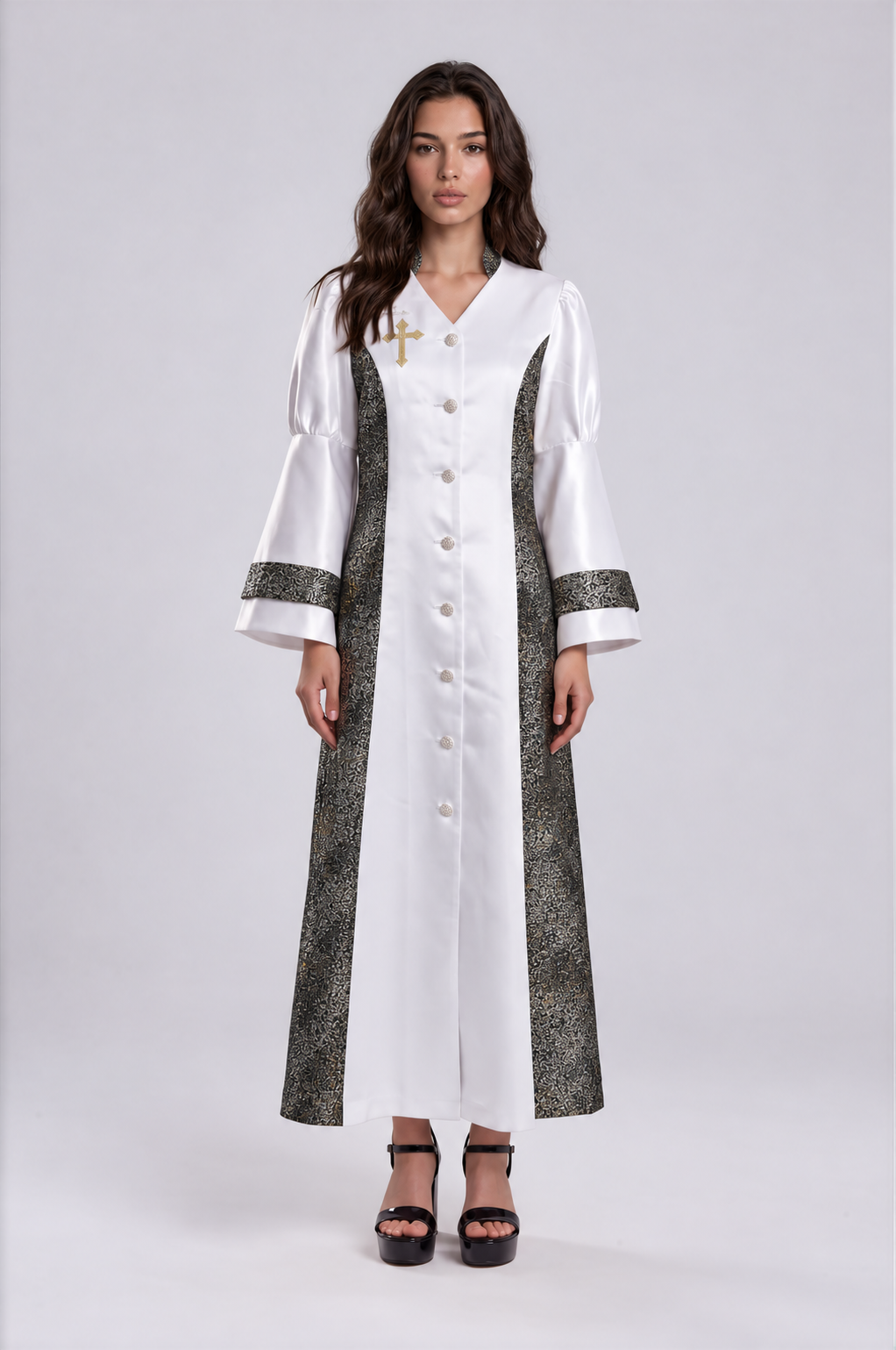 Front view of a model wearing the white and black Tally Taylor Divine Elegance Rhinestone Robe - 4565 with metallic patterned panels, rhinestone buttons and a cross detail