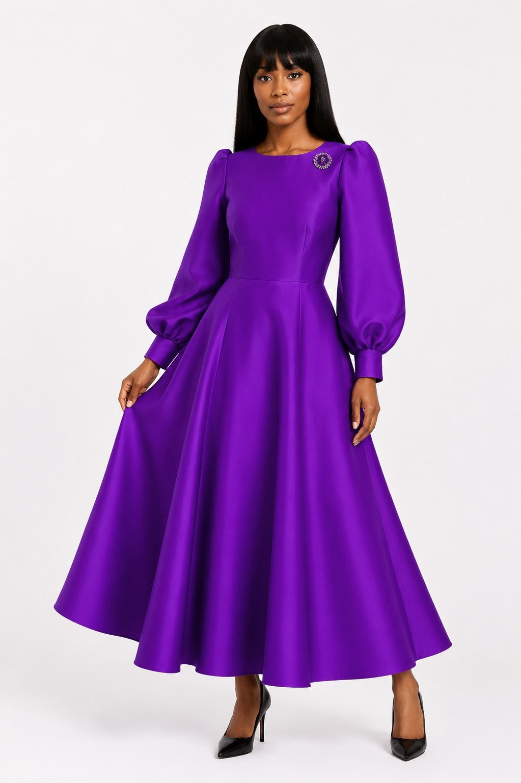 Front view of a model wearing the purple Tally Taylor Elegant Long Dress with Bishop Sleeves - 4820, featuring a jeweled brooch and full skirt