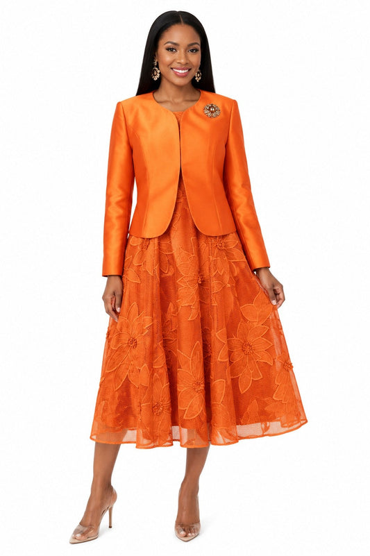 Model wearing the Tally Taylor Floral Lace Dress & Satin Jacket Set in burnt orange, featuring a floral lace midi dress with a coordinating satin jacket and jeweled brooch.