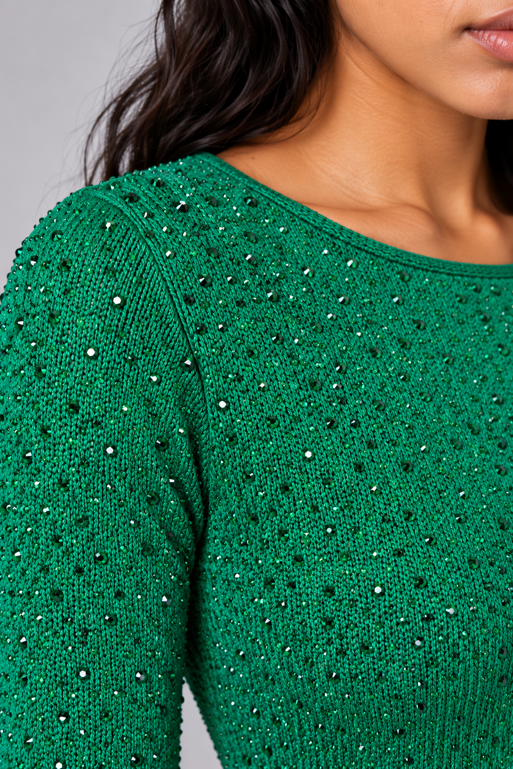 Close-up of a model wearing the green Tally Taylor Glimmer Sheath Dress - 5388, highlighting the textured surface and scattered sparkling embellishments