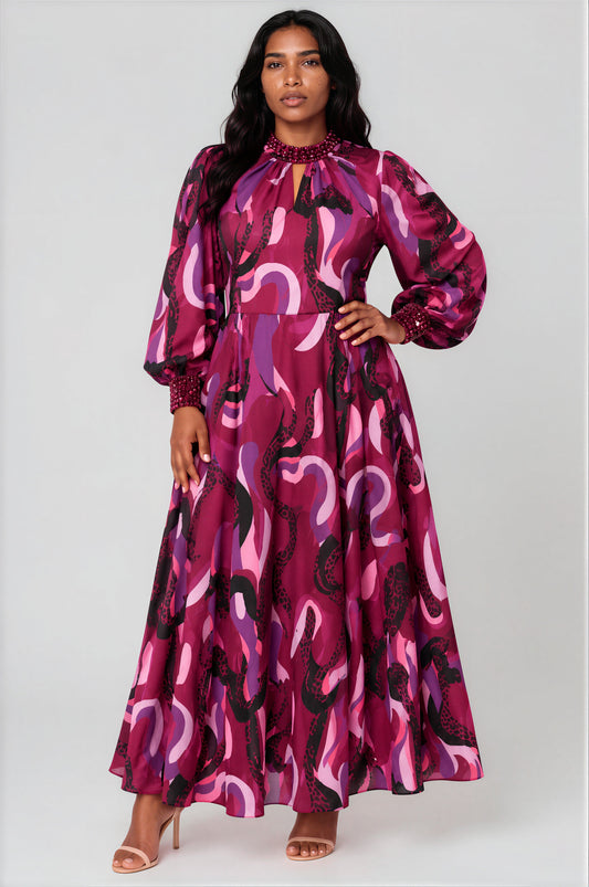 Front view of a model wearing the purple multi Tally Taylor Marbella Printed Maxi Dress - 41038, featuring an abstract print, jeweled high neckline, keyhole detail, and embellished cuffs
