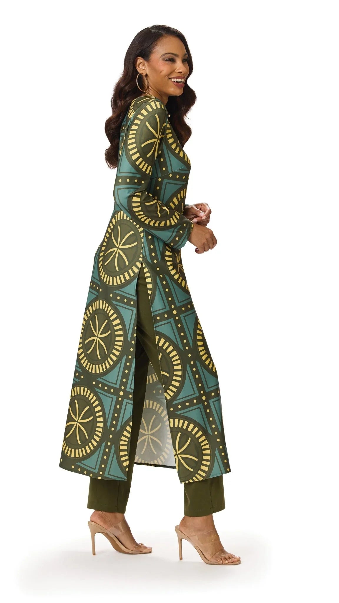 Model posing in the Tally Taylor Geo Circle Print Long Tunic Pant Set in olive green, featuring a bold geometric print, side slits, and coordinating pants, style S0274.