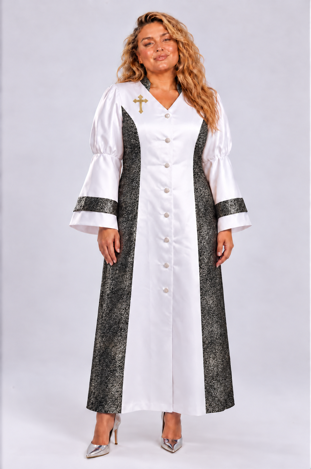 Front view of a plus-size model wearing the white and black Tally Taylor Plus Size Contrast Panel Bell Sleeve Clergy Robe - 4565W with patterned panels, decorative buttons and a cross detail