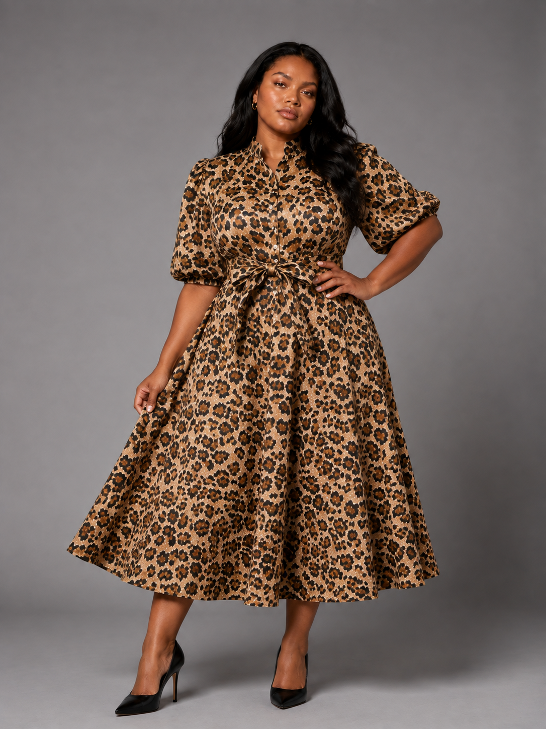 Plus size model wearing the Tally Taylor Animal Print Belted Midi Dress in leopard print, featuring puff sleeves, a button front, and self-tie waist, style S0268W.
