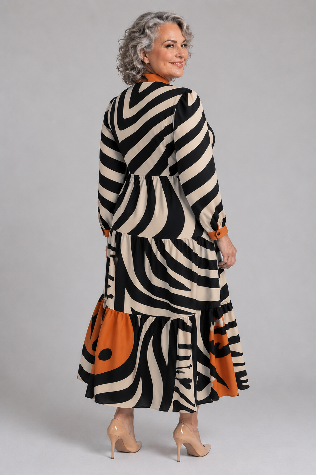 Plus size model wearing the Tally Taylor Wavy Graphic Print Tiered Maxi Dress in black, multi colors, featuring a bold abstract print and tiered skirt, style S0267