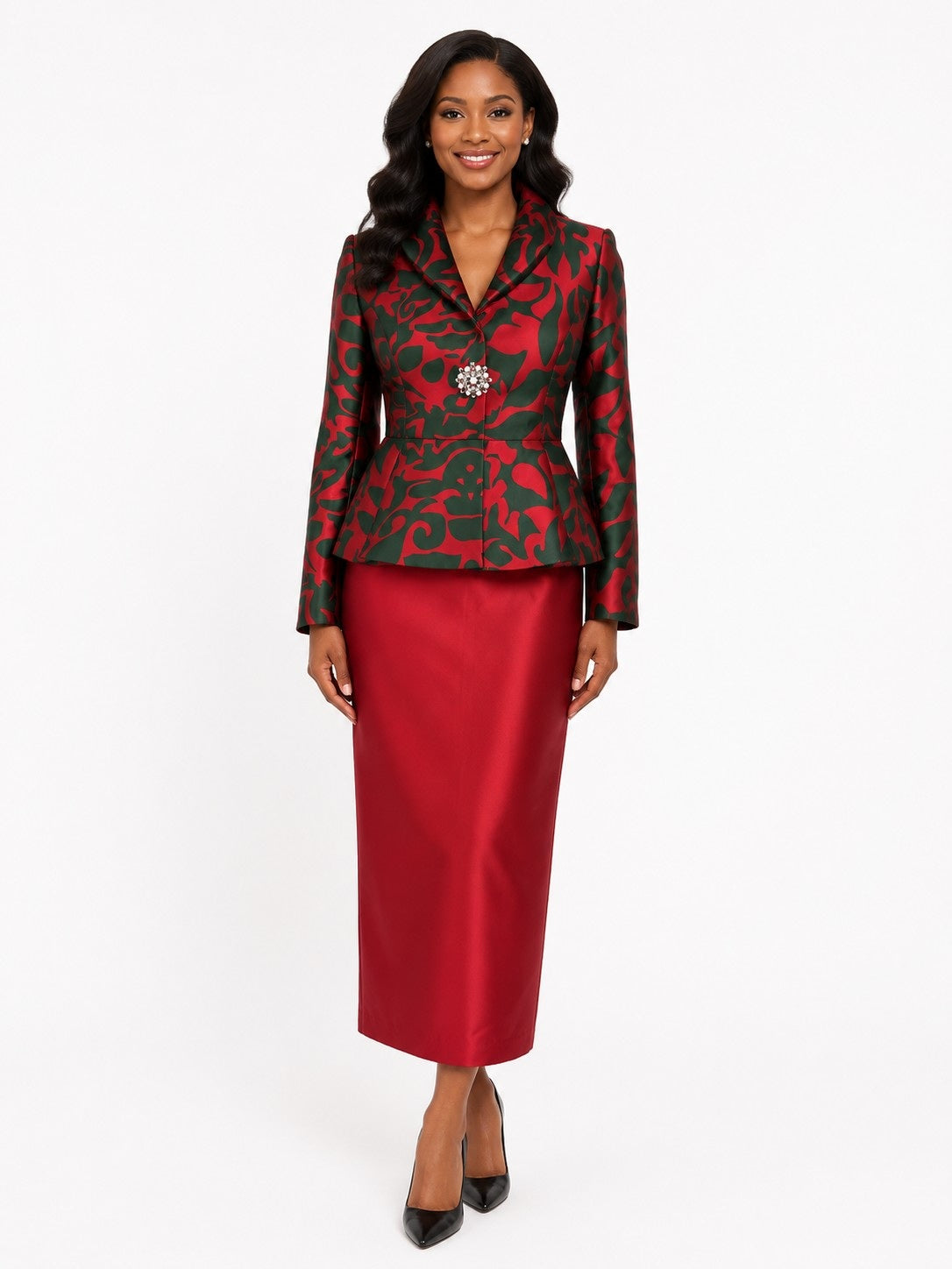 Model wearing the Tally Taylor red floral print jacket and satin skirt set, featuring a jeweled brooch and tailored peplum jacket, style U0109.