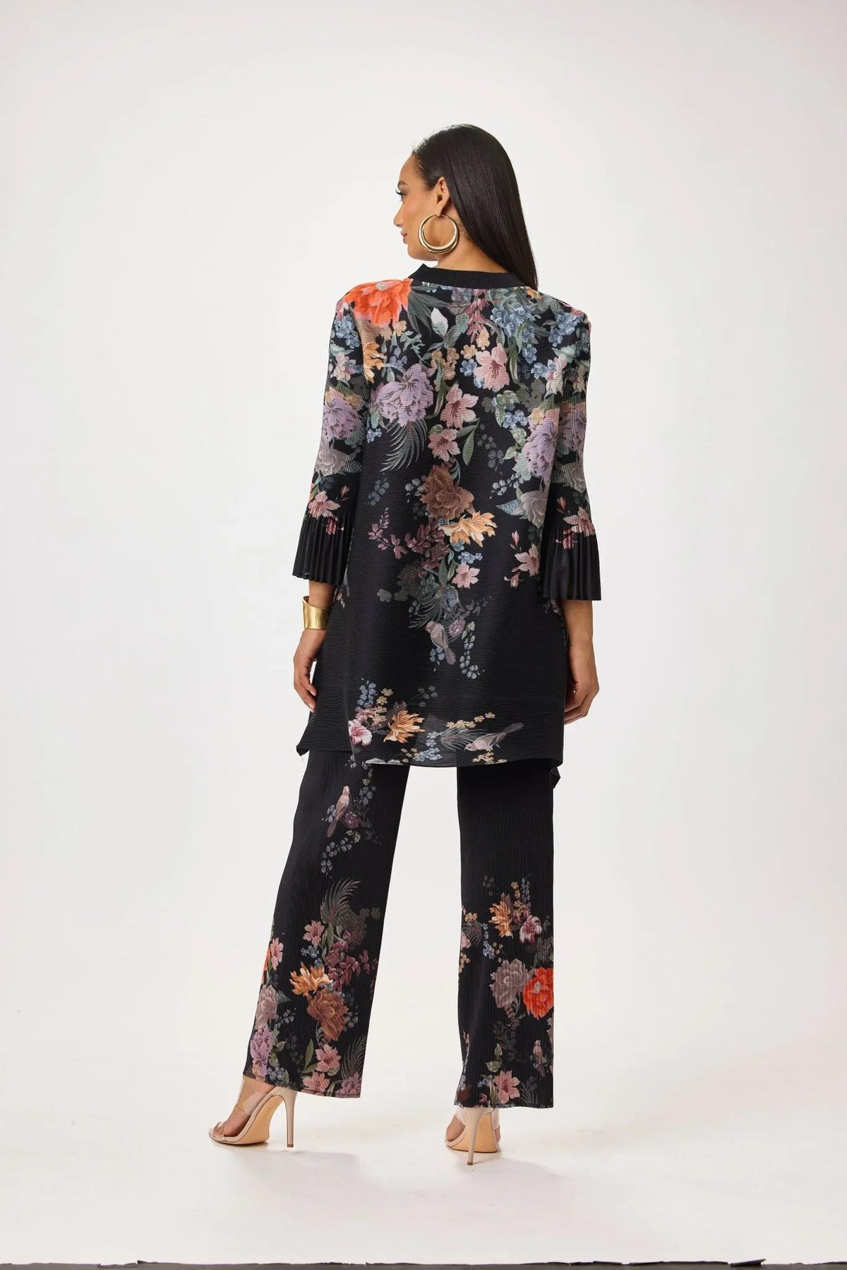 Model wearing the Tally Taylor Spring Garden Print Tunic Pant Set in black with multicolor floral print, button-front tunic and matching pants, style S0105.