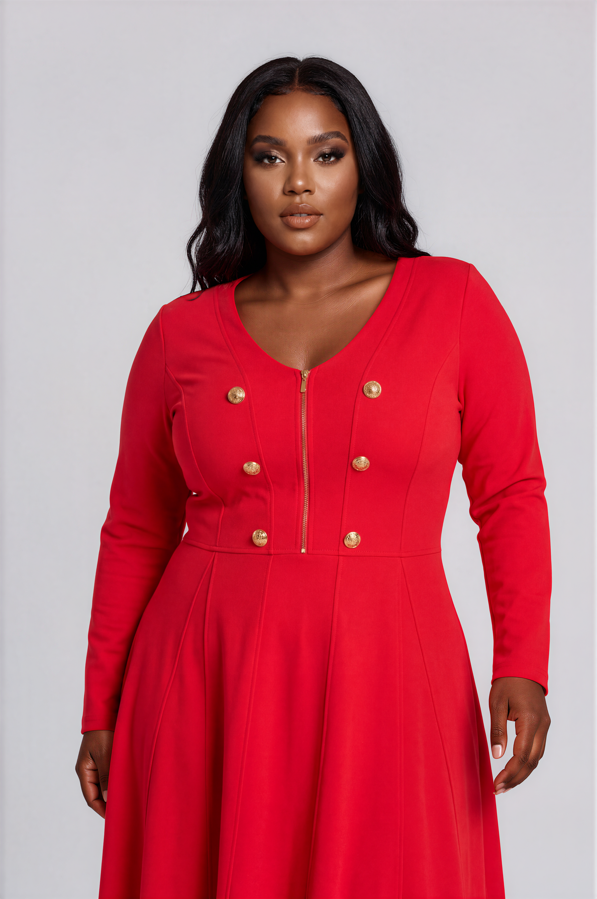 Close-up of a plus-size model wearing the red Tally Taylor V-Neck Knit Dress with Gold Button Details - 51001, highlighting the V-neckline, front zipper, paneled seams, and six gold buttons.
