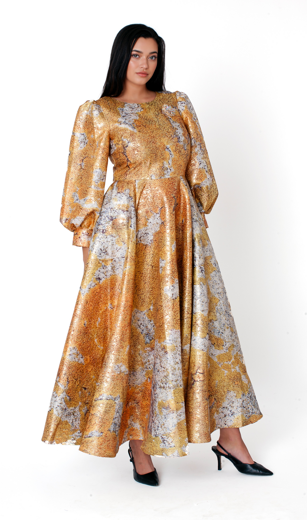 Tally Taylor yellow multi floral brocade maxi dress featuring bishop sleeves, a round neckline, and a decorative brooch shown walking.