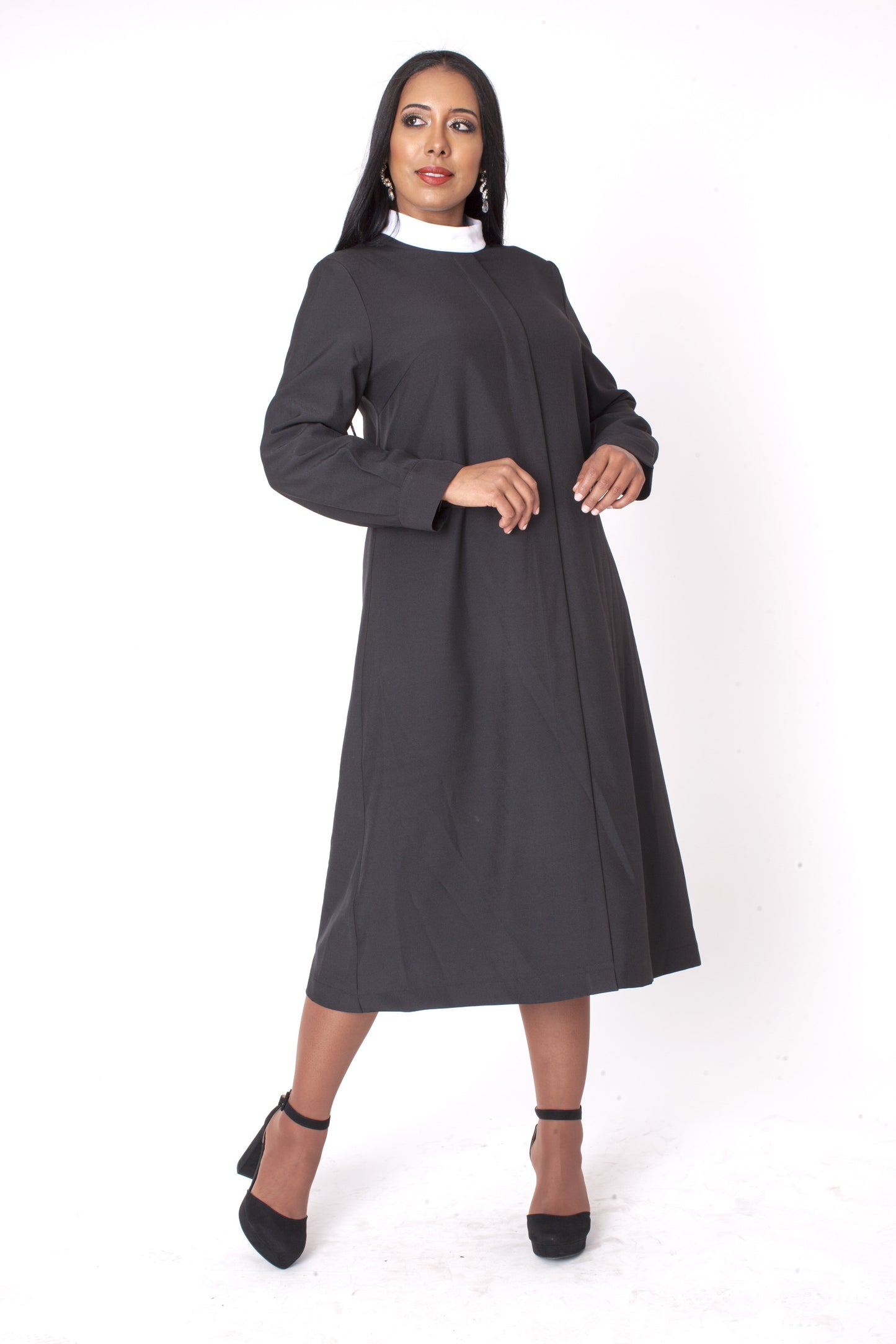 Full length view of black two-piece brocade clergy robe with cross panels on model — Tally Taylor
