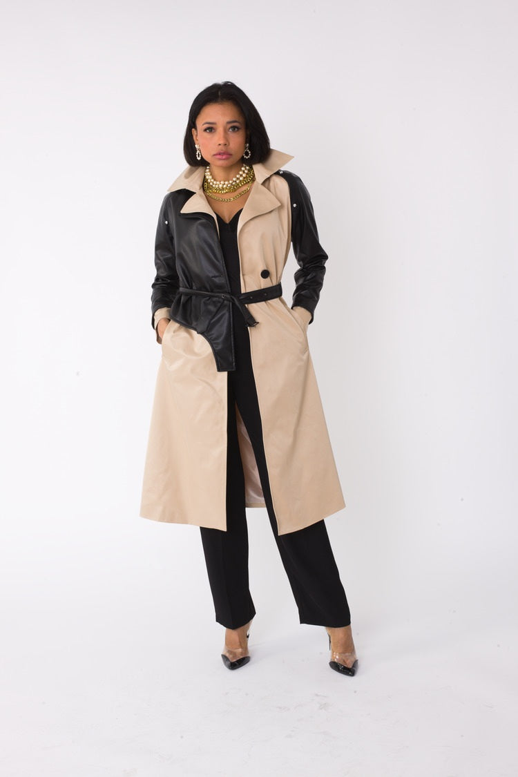Model wearing the khaki and black two tone leather sleeve trench coat standing front facing, showcasing belted waist and mixed material design by For Her NYC